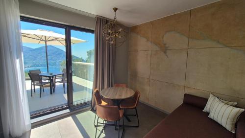 a room with a couch and a table with a view at La Giulia Suites like Home in Bonassola