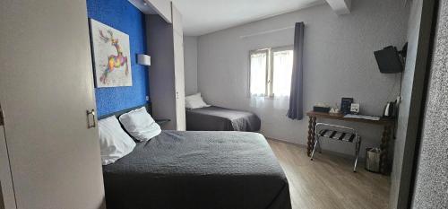a small room with two beds and a window at Hôtel Aragon - Centre ville gare in Perpignan