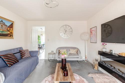 a living room with a blue couch and a table at Town house Anfield stadium in Liverpool