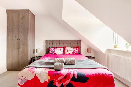 a bedroom with a large bed with a red blanket at Town house Anfield stadium in Liverpool