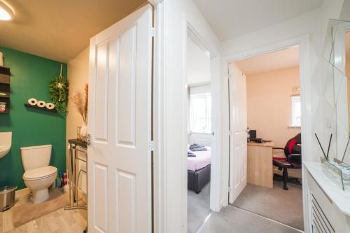 a bathroom with a toilet and a bedroom at Town house Anfield stadium in Liverpool