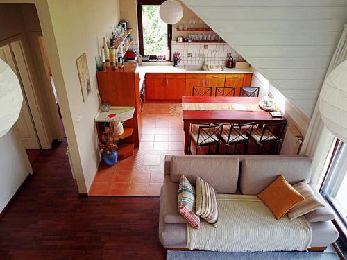 a living room with a couch and a kitchen at Sajkod-az Öböl Csendje in Tihany