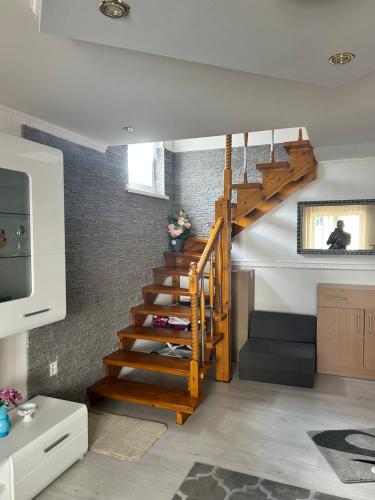 a spiral staircase in a living room with a couch at Ubytovanie u Vlasty in Štrba