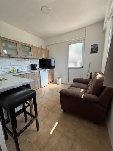 a living room with a couch and a table at Sunflight Apt 01B One Bedroom Apt in Larnaka