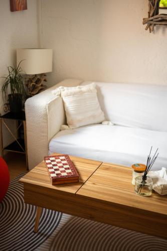 a living room with a white couch and a table at Villa Horizon - 5min from Monaco - Panoramic view - Infinity Pool - Air conditionner - Garden - Parking - Premium Services - Near Monaco Events in Fontvieille