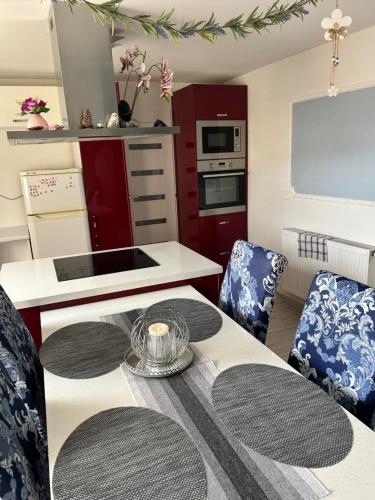 a kitchen with a table and two chairs and a kitchen with a table at Ubytovanie u Vlasty in Štrba