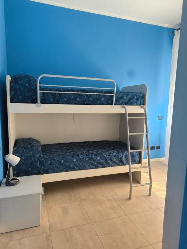 two bunk beds in a room with a blue wall at Sony Affittacamere in Desenzano del Garda