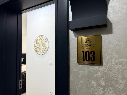 a door with a clock on the side of it at Golden Hill Palace in Novi Pazar