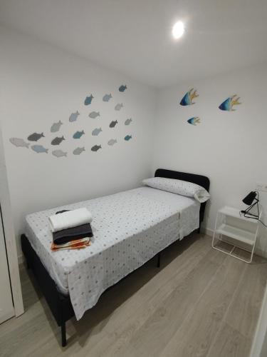 a bedroom with a bed with fish on the wall at Apartamento Bellaluz 0505 Resort Golf La Manga Club in Cartagena