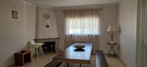 a living room with a table and a fireplace at Villa Papa João XXIII in Fátima