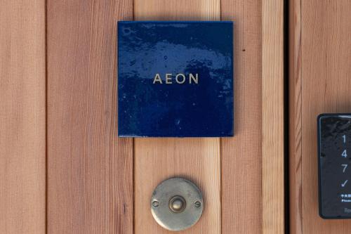 a sign on a door with the word atom on it at Villa NIGIN in Miyazu