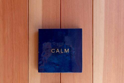 a sign on a wooden door with the word calinn at Villa NIGIN in Miyazu