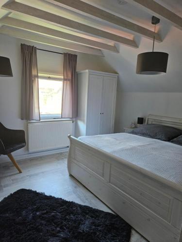 a bedroom with a large bed and a window at Apartment am Lämmerberg in Pößneck