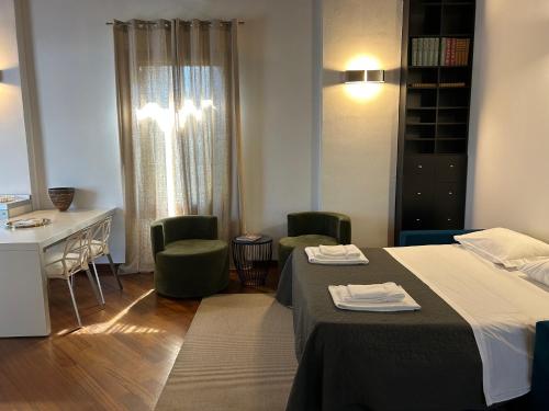 a hotel room with two beds and a desk and chairs at Villa Moro Lin Design Apartments in Mestre