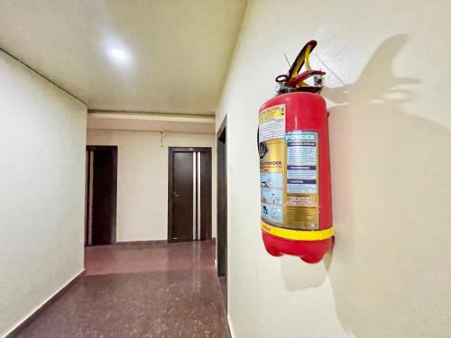 a fire extinguisher hanging on the wall of a room at SEA VIEW- Family Hotel New T B- Resort inn, puri - near sea beach and Jagannath temple in Puri