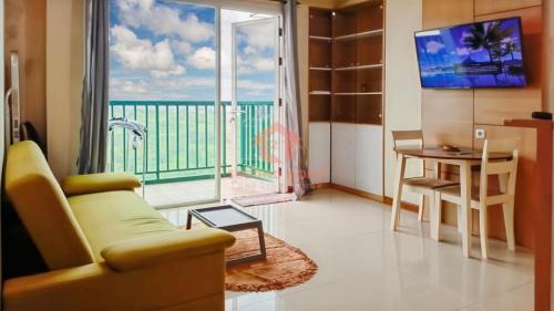 a living room with a couch and a view of the ocean at Marbella 2BR Apt Pool & Wi-Fi in Bandung