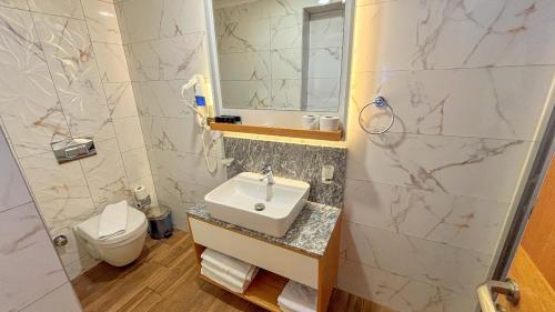 a bathroom with a sink and a toilet at Istankoy Hotel in Bodrum City