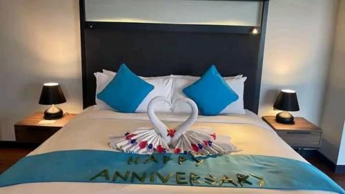 a bed with a heart made out of towels at Avani Sepang Goldcoast Resort in Tanjong Sepat