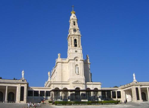 a large white building with a tower on top of it at Villa Papa João XXIII in Fátima