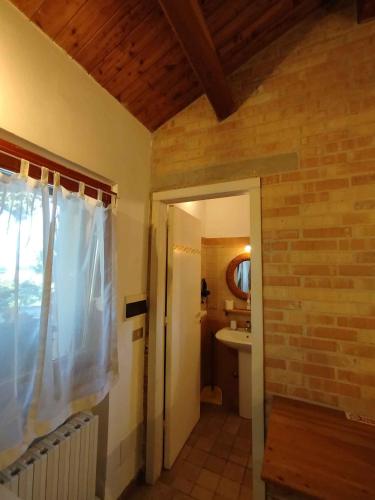 a bathroom with a brick wall and a sink at Il Parco in Ancona