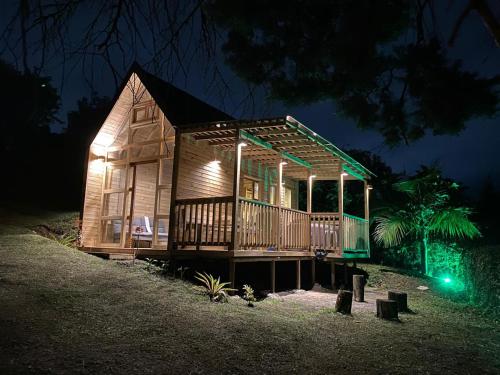 a wooden house with lights on it at night at Hermoso chalet en marinilla in Marinilla