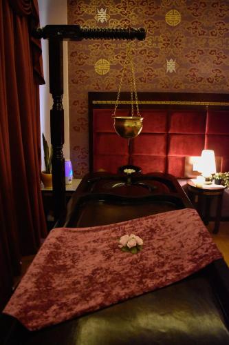 a room with a table with a flower on it at 33 Soksoom Centre for Well-Being & Happinesss - Boutique Hotel in Thimphu
