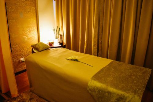 a bedroom with a large bed with yellow curtains at 33 Soksoom Centre for Well-Being & Happinesss - Boutique Hotel in Thimphu