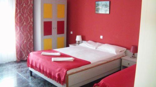 a red bedroom with a bed with red walls at Hotel Dias Apartment in Makrýgialos