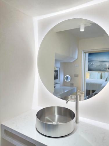 a bathroom with a sink and a mirror at Palazzo Alchimia in Fasano