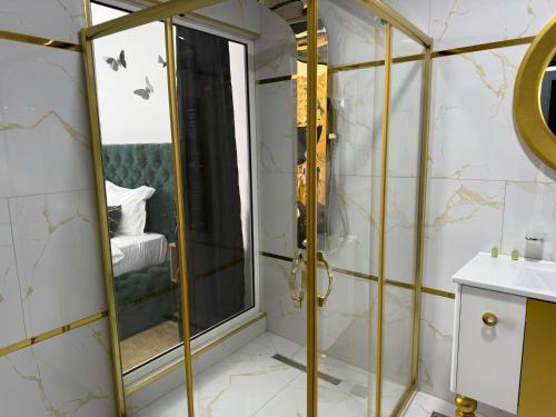 a bathroom with a shower and a mirror at Golden Hill Palace in Novi Pazar