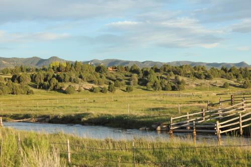 a wooden bridge over a river in a field at Sevier River Ranch & Cattle Company in Hatch