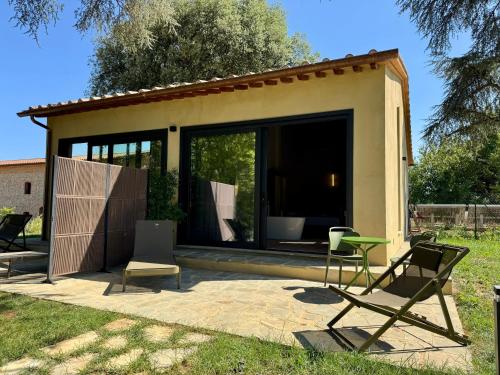 a house with a patio with chairs and a table at The Monteleone Umbria Retreat in Monteleone dʼOrvieto