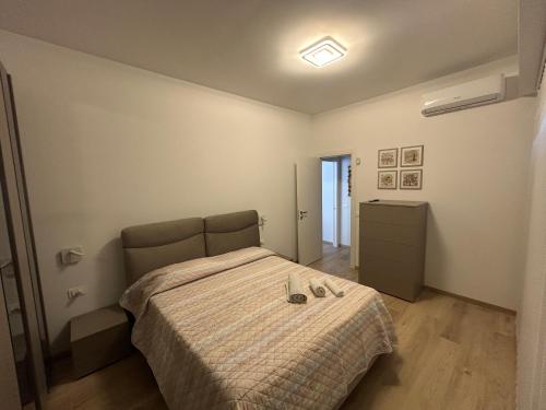 a bedroom with a bed and a dresser in it at BeB Loft Corigliano Rossano CS in Rossano Stazione