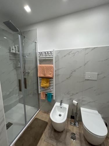 a bathroom with a shower and a toilet and a sink at BeB Loft Corigliano Rossano CS in Rossano Stazione