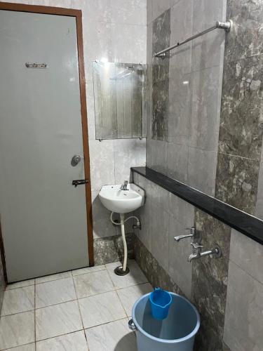 a bathroom with a sink and a toilet and a mirror at EZHIL Residency in Kodaikānāl