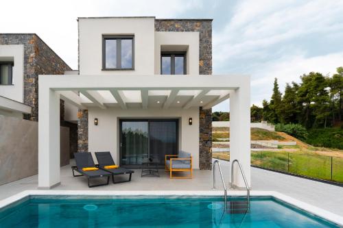 a villa with a swimming pool and a house at Terra Olivia Luxury Villas and Suites in Paliouri