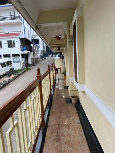 a hallway of a building with a balcony at EZHIL Residency in Kodaikānāl