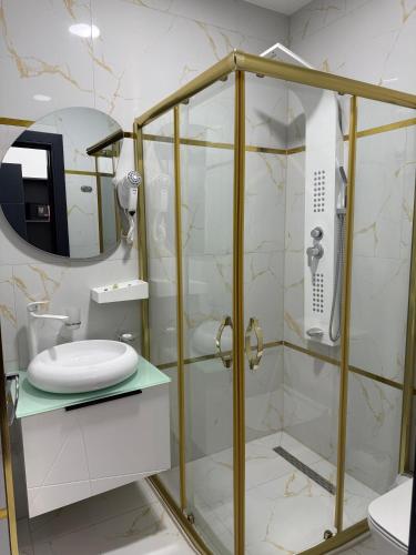 a bathroom with a shower with a toilet and a sink at Golden Hill Palace in Novi Pazar