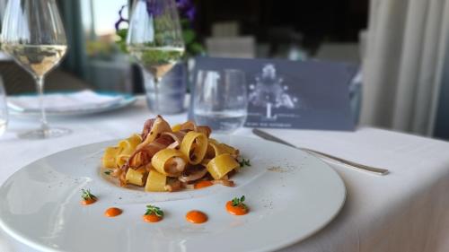 a white plate of food on a table at Hotel Ligure in Alassio
