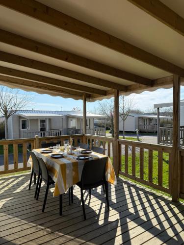 a table and chairs on a deck at Camping de la Loire in Cordemais