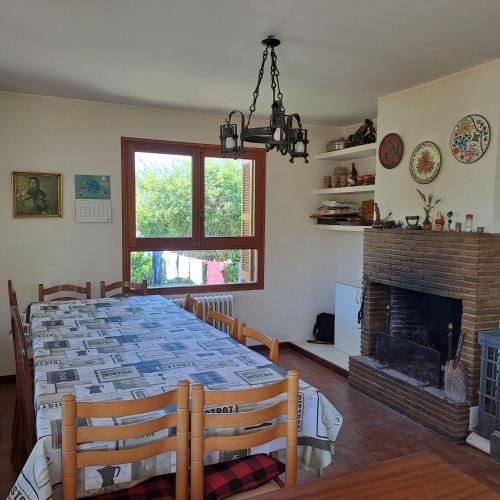 a dining room with a table and a fireplace at Ezemil Etxea in Lumbier