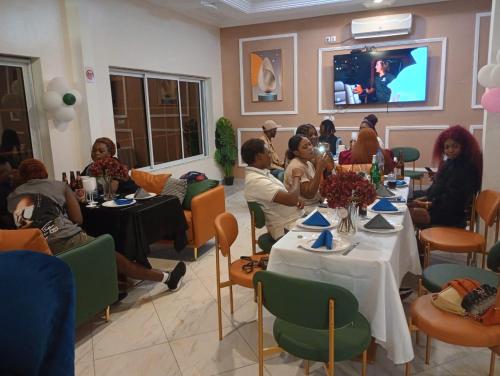 a group of people sitting at tables in a room at The Blue Resort in Yaoundé