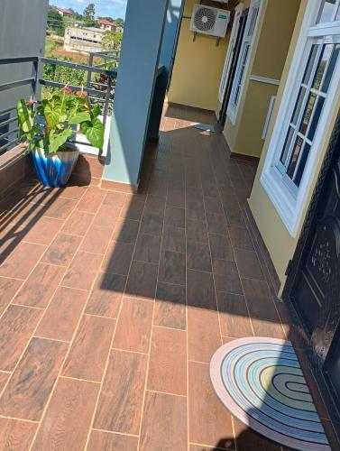 a porch with a tile floor and a balcony at The Blue Resort in Yaoundé