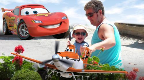 a man and a child cutting into a toy car at Hotel Dias Apartment in Makrýgialos