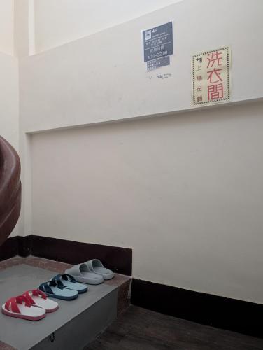 a row of shoes sitting on a shelf in a room at 角舍背包客棧 -近火車站 in Hualien City
