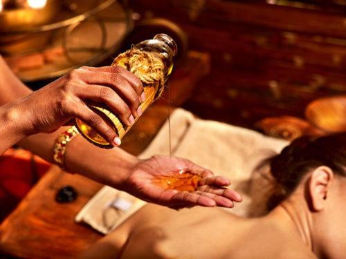 a man is holding a bottle of alcohol and a woman at Nada Brahma Retreats in Dailley