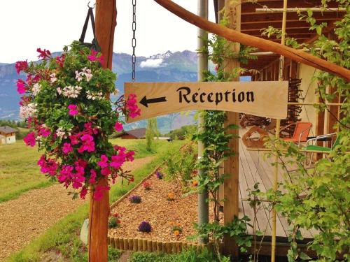 a sign that says reception in front of a garden at Nada Brahma Retreats in Dailley