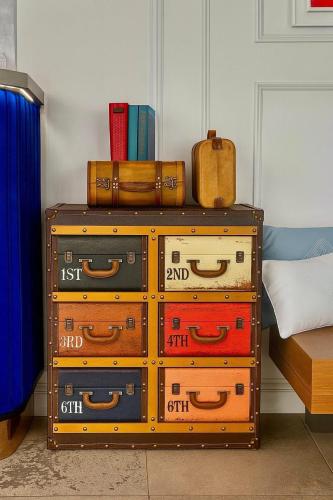 a pile of suitcases sitting on top of a dresser at პანორამა კვარიათი in Kvariat'i