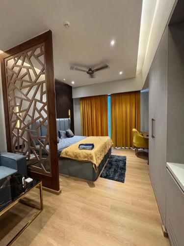 a bedroom with a bed and a large mirror at Galaxy blue sapphire plaza in Ghaziabad