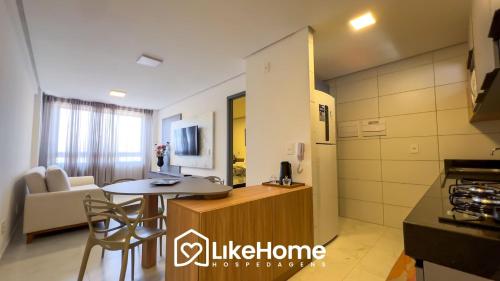 a kitchen and living room with a table and a couch at Edifício Mindset - LikeHome Hospedagens in João Pessoa